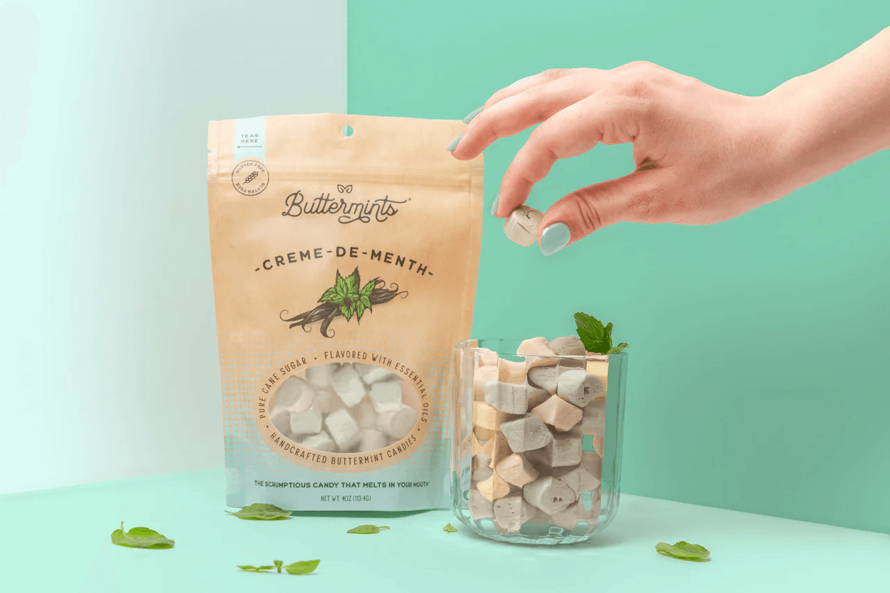 Buttermints creme-de-menth pouch with a hand placing a candy into a glass